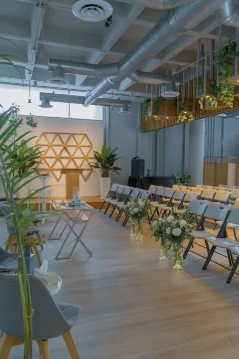 a room with chairs and tables and plants